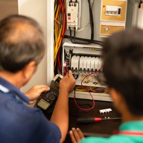 senior-electrician-teaching-trainee-measuring-volt-2025-10-16-04-58-56-utc